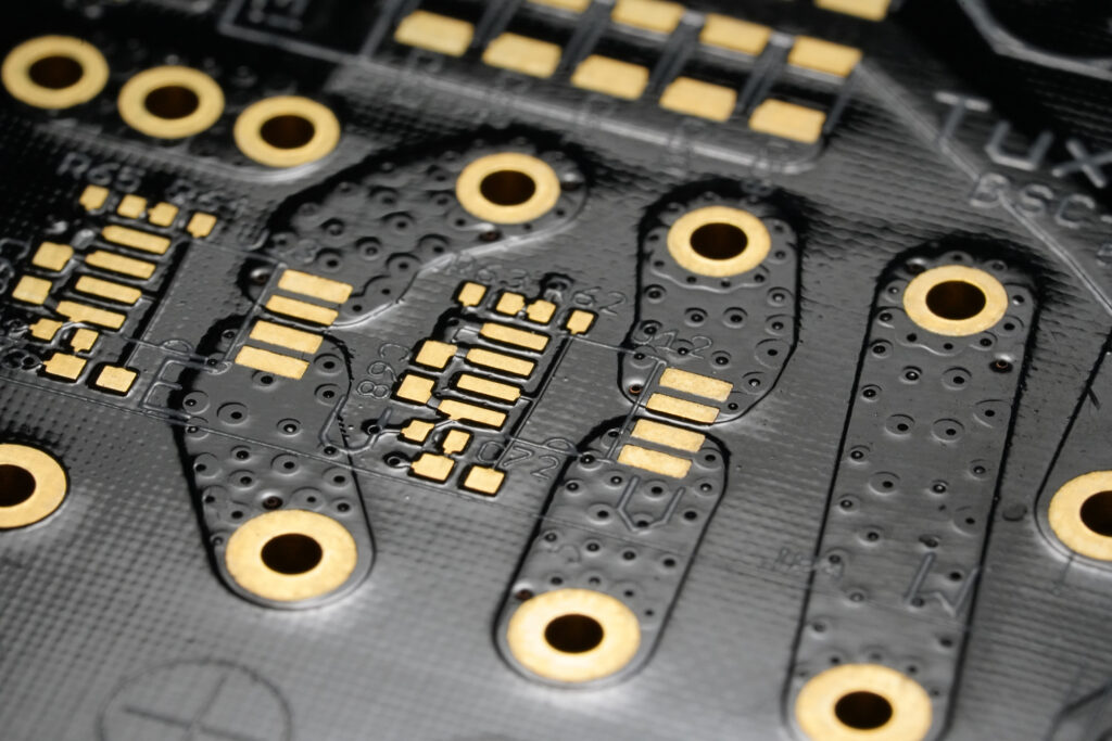 A circuit board with gold-plated components.
